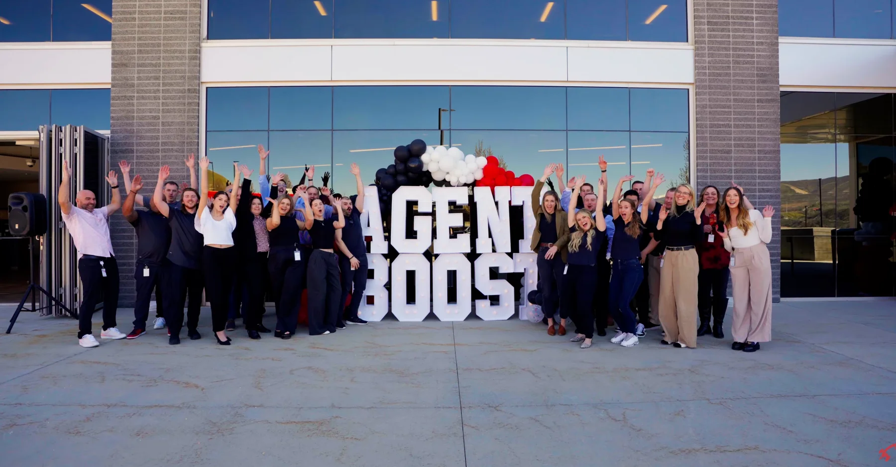 The Agent Boost team celebrating together outside the office